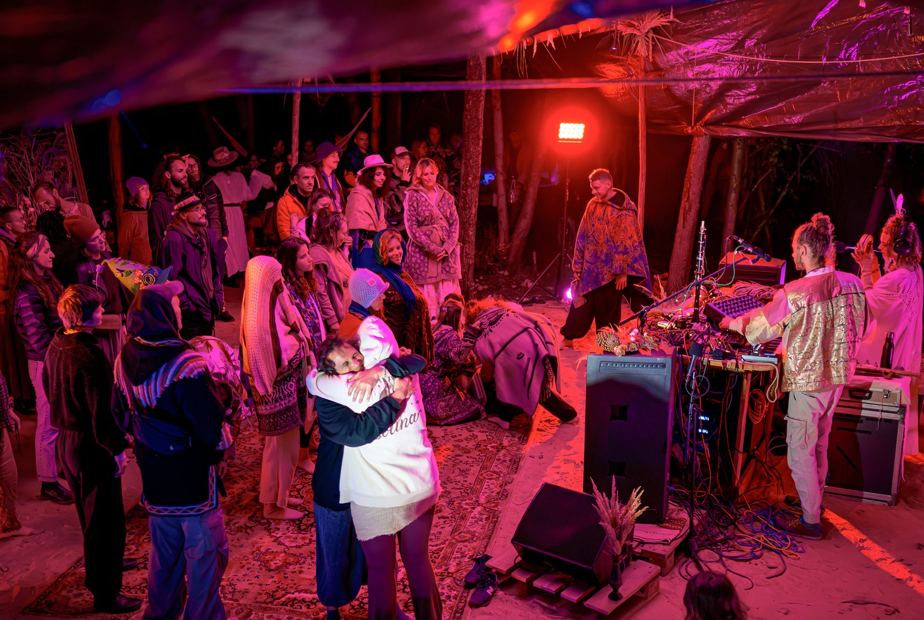 The audience dancing under a canopy at Bagnowianki, red light
